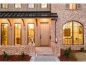 Charming brick home featuring a welcoming front entrance and a unique arched window accent at 1968 S Washington St, Denver, CO 80210