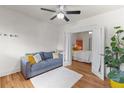 Comfortable living room with a plush couch and direct access to a well-lit bedroom at 2465 W Caithness Pl, Denver, CO 80211