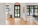 Bright entryway with large arched front door and modern black window frames offer beautiful natural light at 4452 Xavier St, Denver, CO 80212