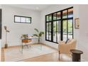 Bright office space with clear desk, large window, wood floors, and neutral decor at 4452 Xavier St, Denver, CO 80212