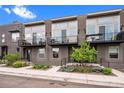 Modern townhomes with black iron railings and gray exterior paint, plus a small balcony at 3480 E 31St Ave, Denver, CO 80205