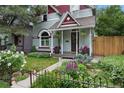 Inviting front porch featuring a porch swing, potted flowers, and lush landscaping at 3424 W 31St Ave, Denver, CO 80211