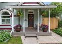 Charming front porch with swing, potted flowers, and painted wood columns at 3424 W 31St Ave, Denver, CO 80211