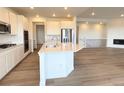 Bright kitchen featuring white cabinets, stainless steel appliances, and a spacious island at 3979 Descent St, Castle Rock, CO 80108