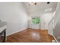 Bright living room featuring vaulted ceiling, hardwood floors, and a large window allowing ample natural light at 5441 Lynx St, Frederick, CO 80504