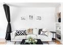 Comfortable living room with a white sofa, decorative pillows, and neutral accents that create a relaxing atmosphere at 2313 S Race St # A, Denver, CO 80210