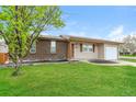 Single-story home with a well-maintained lawn and landscaping at 405 Cypress St, Broomfield, CO 80020