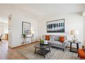 Cozy living room featuring hardwood floors, neutral-toned furniture, and stylish decor at 9652 Cove Creek Dr, Highlands Ranch, CO 80129