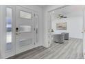 Bright foyer featuring a modern door with sidelights and stylish wood-look flooring at 2545 S Leyden St, Denver, CO 80222