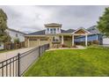 Charming two-story home featuring an inviting front yard, balcony, and a spacious two car attached garage at 940 Kearney St, Denver, CO 80220