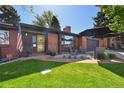 Inviting brick home entrance with manicured lawn and cozy outdoor seating at 2774 S Milwaukee St, Denver, CO 80210