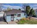 Charming home featuring light blue horizontal siding, a well-kept lawn and mature landscaping at 1108 Roslyn St, Denver, CO 80220