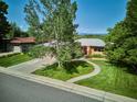 Charming home with a well-maintained lawn, mature trees, and inviting curb appeal at 2300 Crabtree Dr, Centennial, CO 80121