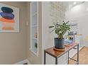 Entryway with hardwood floors, built-in shelving, and modern decor elements leading to the kitchen at 936 Utica St, Denver, CO 80204