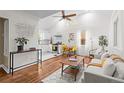 Bright open-concept living space featuring hardwood floors, a modern kitchen, and vaulted ceilings at 936 Utica St, Denver, CO 80204