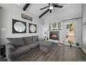 Cozy living room with fireplace, wood accents, comfortable seating, and bright natural light at 153 Sawmill Ln, Idaho Springs, CO 80452