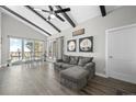 Bright living room with vaulted ceilings, dark beams, and large windows with outdoor views at 153 Sawmill Ln, Idaho Springs, CO 80452