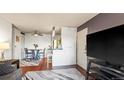 Comfortable living space with hardwood floors and access to dining area at 7881 Allison Way # 204, Arvada, CO 80005