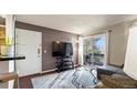Inviting living room with a sliding glass door to a private balcony at 7881 Allison Way # 204, Arvada, CO 80005
