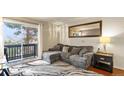Bright living room featuring a sliding glass door to a private balcony and neutral colors at 7881 Allison Way # 204, Arvada, CO 80005