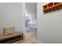 Welcoming entryway with a decorative bench, a coat rack, and a glimpse into the bright, open living spaces at 5677 S Park Pl # 303, Englewood, CO 80111