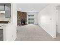 Living room with a fireplace and sliding door to balcony at 1980 S Xanadu Way # 208, Aurora, CO 80014
