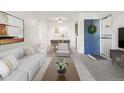 Bright living room flowing into dining area, featuring modern decor at 1980 S Xanadu Way # 208, Aurora, CO 80014