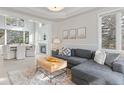 Stylish living room with an open floor plan and a view of the dining area at 31699 Southern Hills Pl, Evergreen, CO 80439