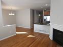 Open concept dining area with hardwood floors and fireplace at 8436 E 35Th Ave, Denver, CO 80238