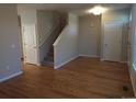 Bright living room with hardwood floors and staircase at 8436 E 35Th Ave, Denver, CO 80238