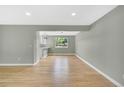 Open dining room with hardwood floors and neutral walls leads to a modernized kitchen at 2122 S Zephyr St, Lakewood, CO 80227