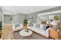 Bright living room with hardwood floors, neutral walls, stylish furniture, and open floor plan at 2122 S Zephyr St, Lakewood, CO 80227