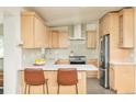 Modern kitchen with stainless steel appliances, quartz counters, and light wood cabinets at 2849 E Cresthill Ave, Centennial, CO 80121