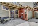 Charming home exterior features a brick accent wall and cozy bench seating near the front door at 12831 King St, Broomfield, CO 80020