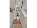 Bright hallway featuring hardwood floors leading into the living area and a staircase at 12831 King St, Broomfield, CO 80020