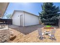 Inviting backyard with a fire pit, chairs, and well-kept landscaping at 6338 W 92Nd Pl, Westminster, CO 80031