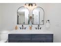 Modern bathroom with double sinks, sleek fixtures, and contemporary mirrors at 6338 W 92Nd Pl, Westminster, CO 80031