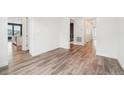 Hallway with hardwood floors leading to a bright, modern kitchen at 5128 Preserve Pl, Firestone, CO 80504