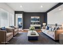 Beautiful living room features a modern design, stylish furniture, and hardwood floors at 5128 Preserve Pl, Firestone, CO 80504