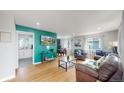 Bright living room featuring hardwood floors, stylish furnishings, and an open floor plan at 1852 S Forest St, Denver, CO 80222