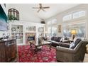 Spacious living room featuring a brick fireplace, built-in shelving, and large windows at 10889 Alcott Ct, Denver, CO 80234