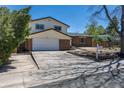View of a two-story home with a front yard, a driveway, and an attached two-car garage at 3256 S Nucla St, Aurora, CO 80013
