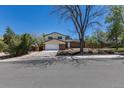 A two-story house with a two-car garage and a landscaped front yard under a clear blue sky at 3256 S Nucla St, Aurora, CO 80013