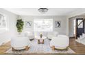 Bright living room with stylish furnishings, hardwood floors, and a large window overlooking the front yard at 3100 S Holly Pl, Denver, CO 80222