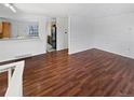Spacious living area featuring beautiful hardwood floors, neutral walls, and an open layout at 1045 Mobile St, Aurora, CO 80011