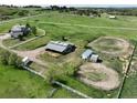 The aerial view captures the horse property with paddocks, loafing sheds, and riding areas at 595 W Oak Hill Ln, Castle Rock, CO 80108
