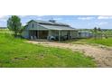 Well-maintained horse barn with open stalls, ample storage, and a covered area for equipment at 595 W Oak Hill Ln, Castle Rock, CO 80108