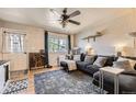 Cozy living room boasts modern decor, a comfortable sectional sofa, and a bright window with natural light at 1756 S Memphis St, Aurora, CO 80017