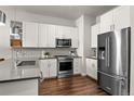 Sleek kitchen with stainless steel appliances, subway tile backsplash, and ample cabinet space at 20 Wilcox St # 203, Castle Rock, CO 80104