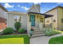 Inviting bungalow with awning, landscaping, and well-maintained lawn at 1208 S Elizabeth St, Denver, CO 80210